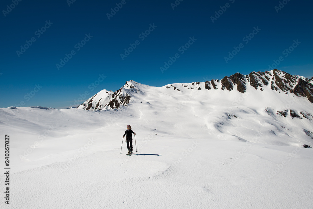 Single woman practicing ski mountaineering on the Alps Single woman practicing ski mountaineering on the Alps