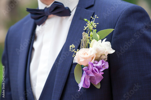 Wedding boutonniere on suit of groom.