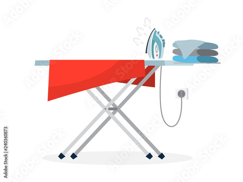 Iron and pile of clothes on ironing board.