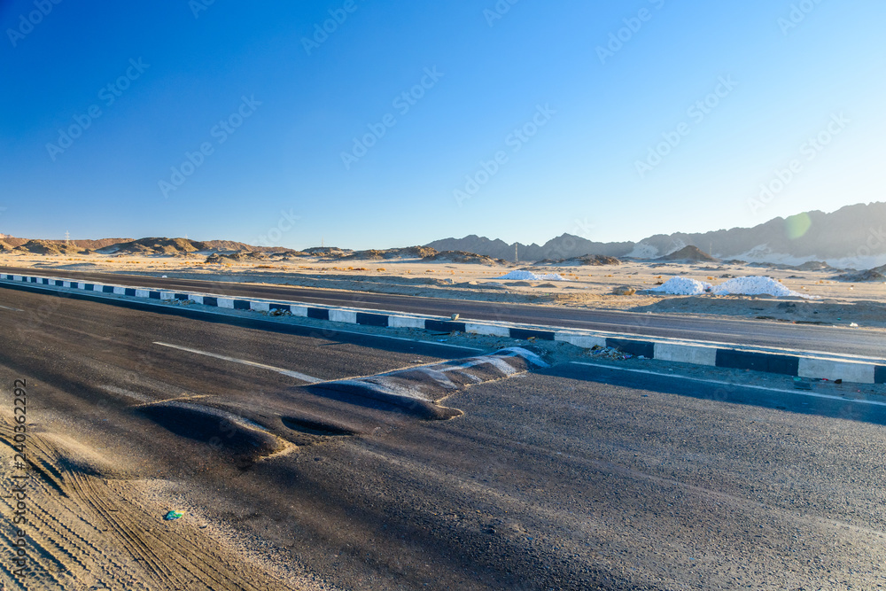 Asphalt road in arabian desert not far from the Hurghada city, Egypt