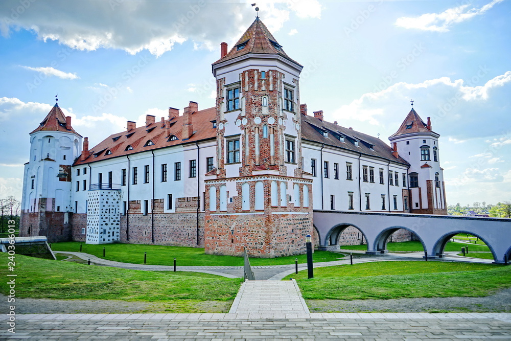 A beautiful ancient medieval castle with a red brick fortress wall