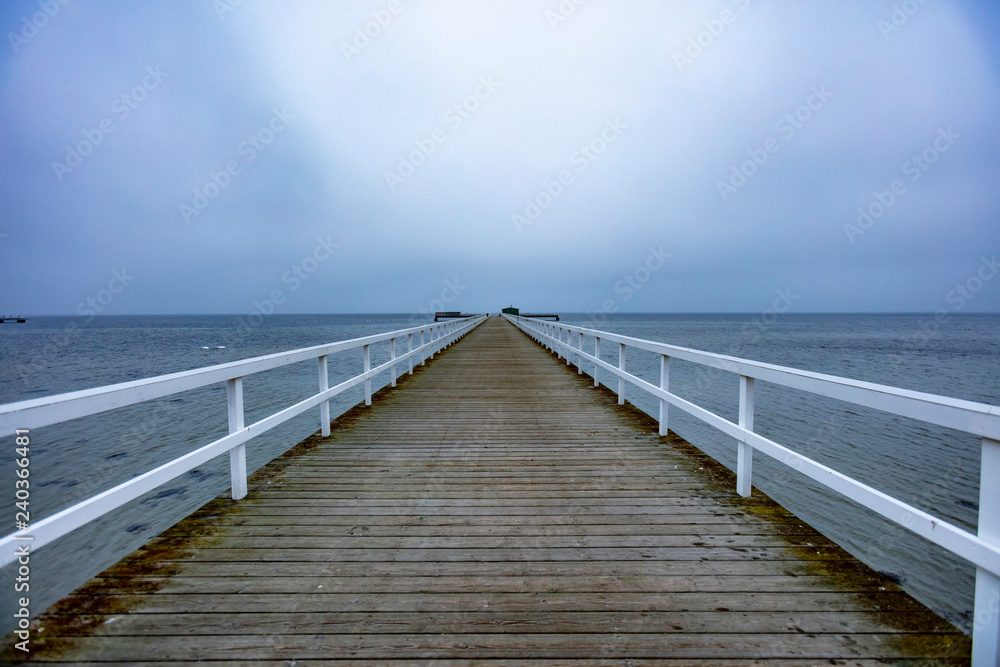 wooden pier on winter sea 