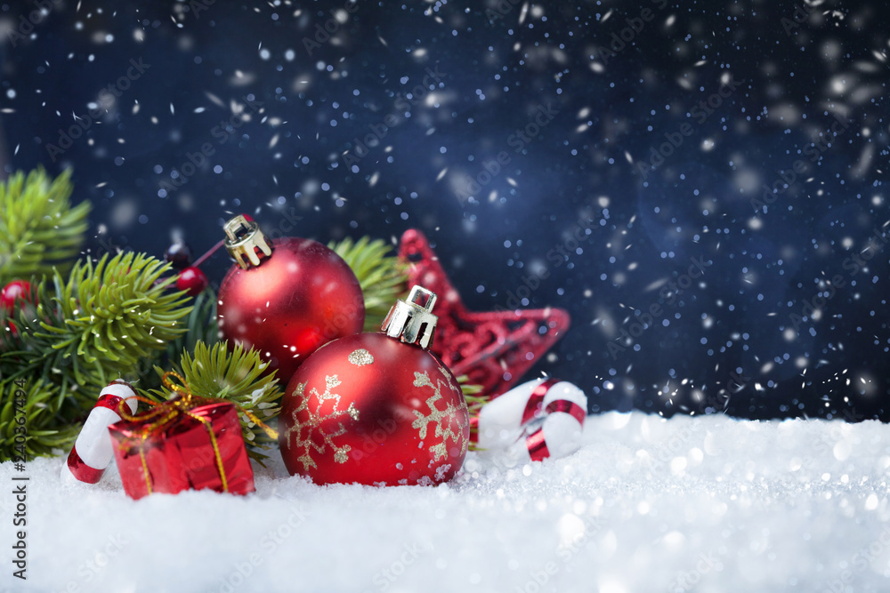 Christmas balls with tree and decorations on snow