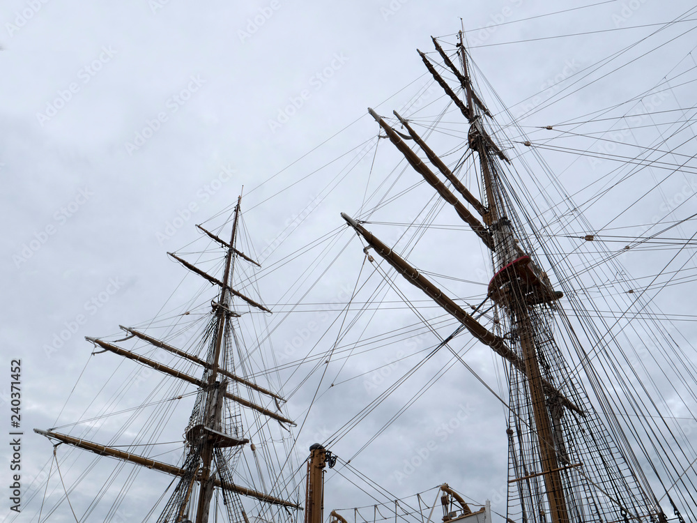 Masts and the rigging of ancient sailboat on nignt sky background. Exterior of old tall ship. Amerigo Vespucci - bow of ancient sailing vessel. Masts and the rigging of ancient sailboat on nignt sky background. Exterior of old tall ship. Amerigo Vespucci - bow of ancient sailing vessel.