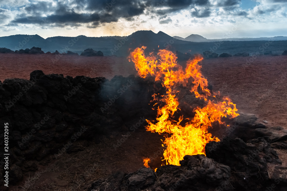 Vulcanic Landscape with fire of the Timanfaya National Park in Lanzarote, Canary Islands, Spain