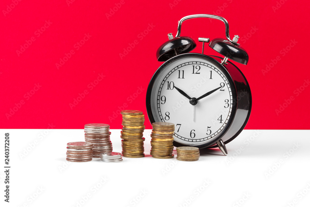 Alarm clock and money coins on the table. Alarm clock and money coins on the table.