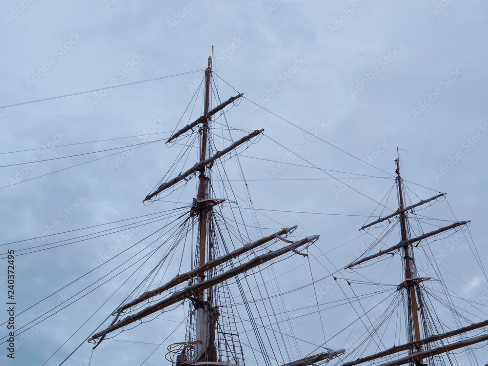 Masts and the rigging of ancient sailboat on nignt sky background. Exterior of old tall ship. Amerigo Vespucci - bow of ancient sailing vessel. Masts and the rigging of ancient sailboat on nignt sky background. Exterior of old tall ship. Amerigo Vespucci - bow of ancient sailing vessel.