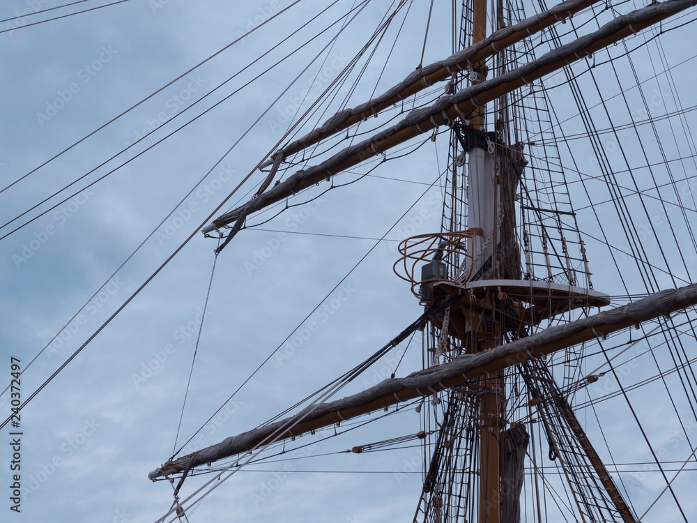 Masts and the rigging of ancient sailboat on nignt sky background. Exterior of old tall ship. Amerigo Vespucci - bow of ancient sailing vessel. Masts and the rigging of ancient sailboat on nignt sky background. Exterior of old tall ship. Amerigo Vespucci - bow of ancient sailing vessel.