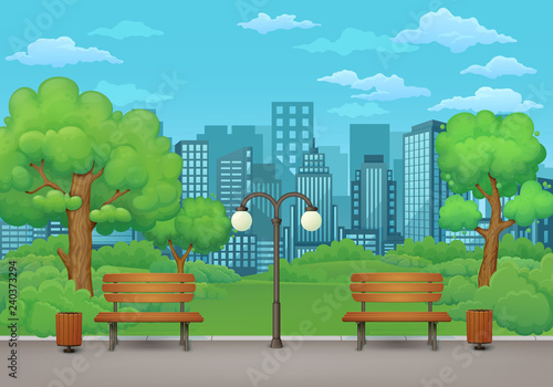 Summer day in the park. Benches, trash cans and street lamp on an asphalt park trail with lush green trees and bushes. Green meadows and cityscape in the background.