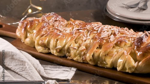 Christmas braided cinnamon cake on festive table. photo