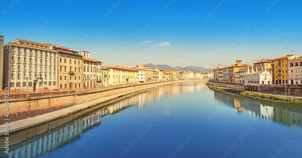 Wide panoramic view of the embankment of The Arno River in Pisa. Travel in Italy and Tuscany concept