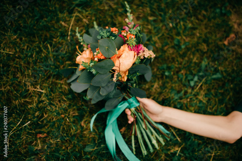 Wallpaper Mural Close-up of girl's Hand and bouquet of flowers lying on ground Torontodigital.ca