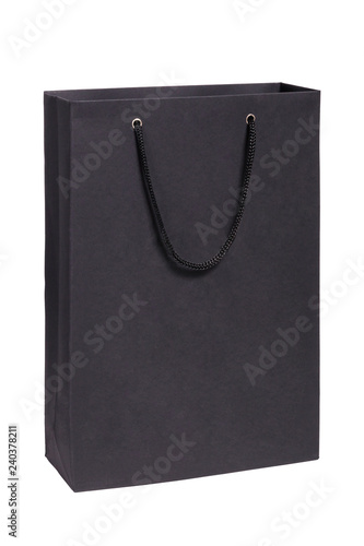 Closeup black paper empty package with handles isolated on white background. Concept retail, shopping, stylish laconic packaging of underwear, alcohol, christmas gifts, funereal package