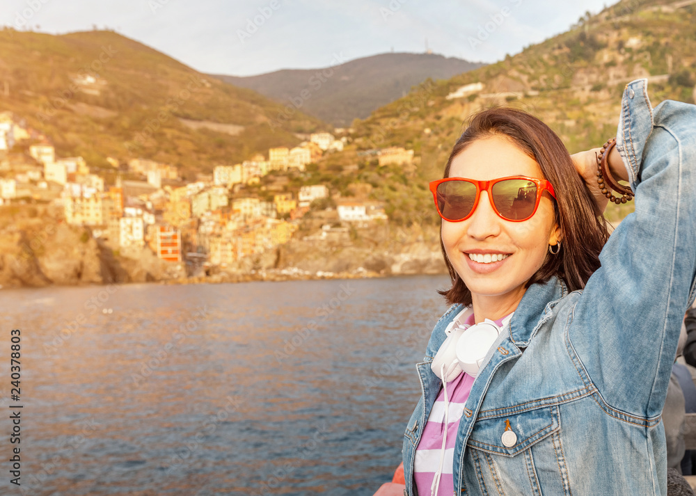 Happy asian woman at the boat cruise in Cinque Terre sea cost, Italy
