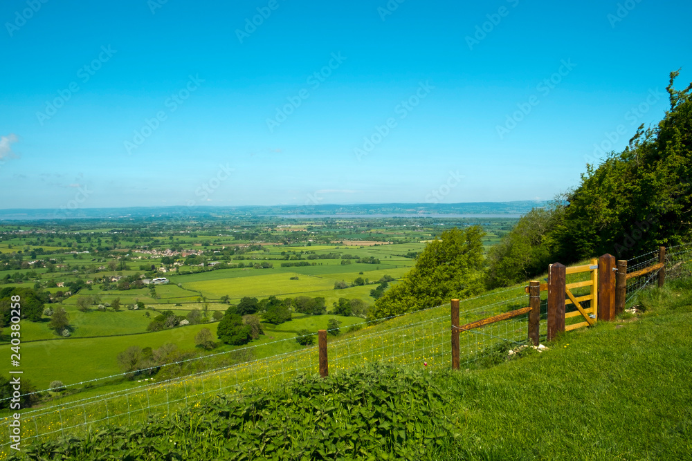 Extensive view towards the River Severn and The Forest of Dean over a patchwork of fields, Coaley Peak Picnic Site and Viewpoint, Gloucestershire, UK