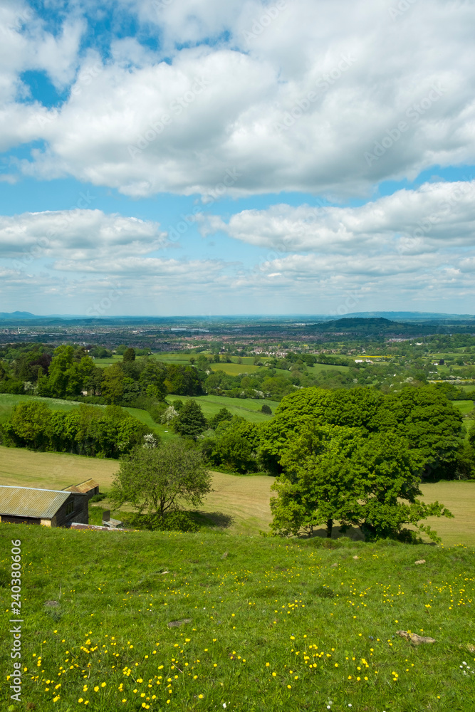 Extensive views over the City of Gloucester in the Severn Vale with the Malvern Hills in the distance. From Cud Hill Common on the western edge of the Cotswolds, Gloucestershire, England, UK