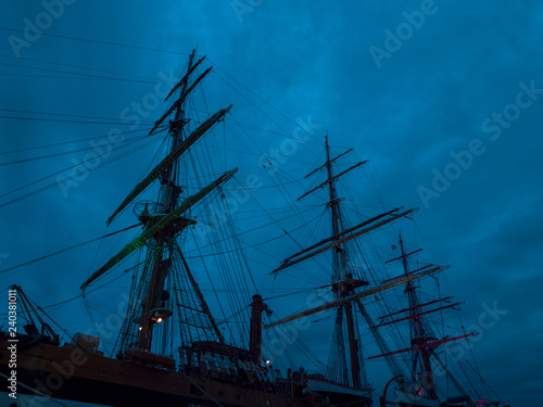 Masts and the rigging of ancient sailboat on nignt sky background. Exterior of old tall ship. Amerigo Vespucci - bow of ancient sailing vessel.