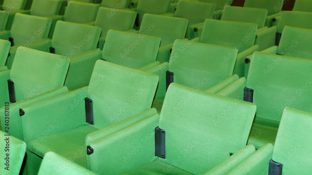 Conference hall o seminar room, rows of empty green seat in auditorium Conference hall o seminar room, rows of empty green seat in auditorium