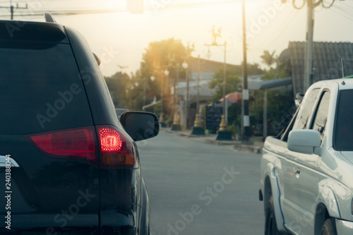 Black car break on the road for safety in traffic junction there are many cars on the road.