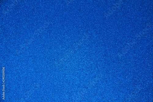 An abstract blue background made of twinkling glitter that is great for a background for Christmas and other celebrations.