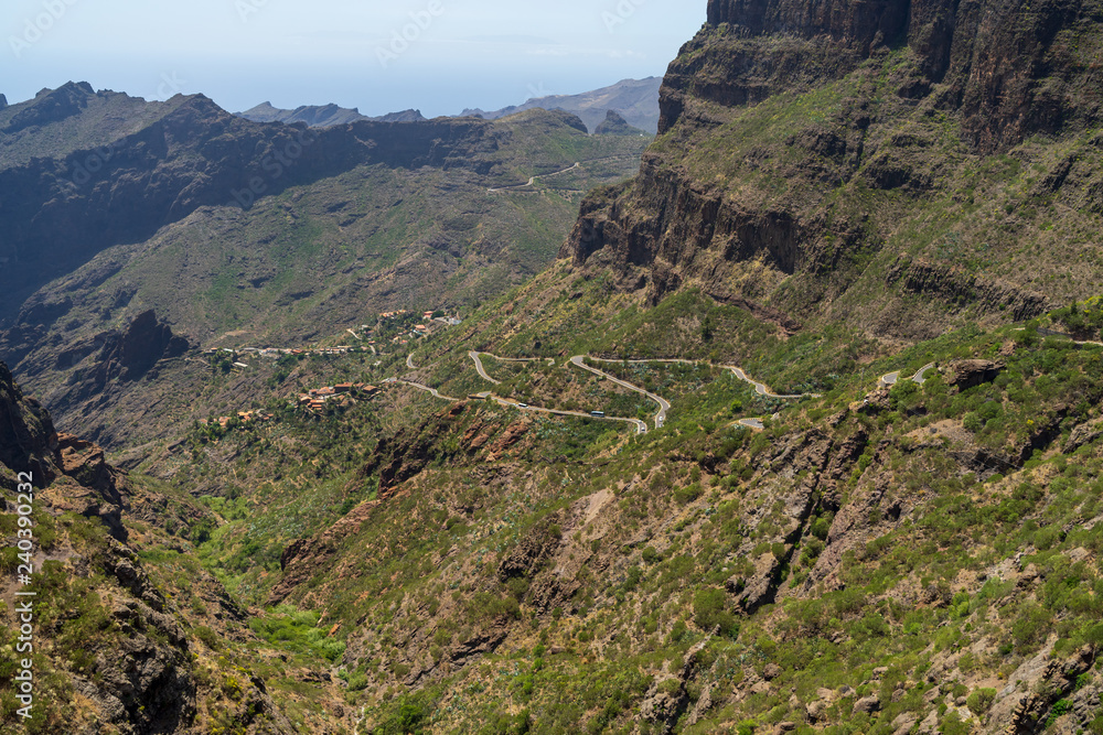 Vew of the Macizo de Teno mountains, Masca Gorge and mountain road to the village of Maska. View from the viewpoint - Mirador De Masca. Tenerife. Canary Islands. Spain. Vew of the Macizo de Teno mountains, Masca Gorge and mountain road to the village of Maska. View from the viewpoint - Mirador De Masca. Tenerife. Canary Islands. Spain.