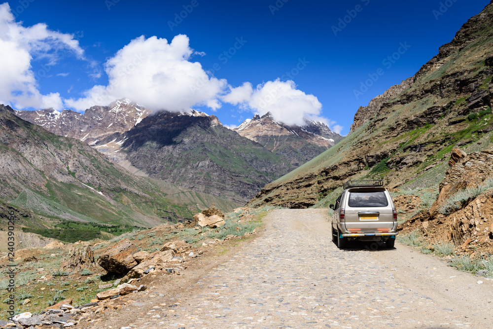 A car travel along the  road on Manali-Leh highway in  Ladakh, Himachal Pradesh, India