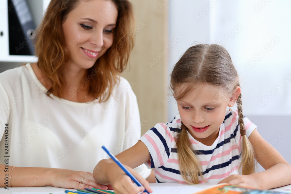 Blond little girl hold in arm pencil drawing something Blond little girl hold in arm pencil drawing something