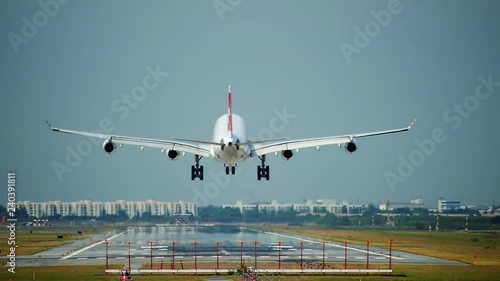 Commercial aeroplane or airliner on a final approaching landing at an International Airport on a clear morning sky