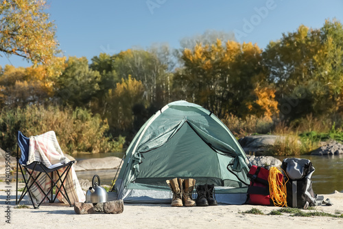 Set of equipment near camping tent outdoors