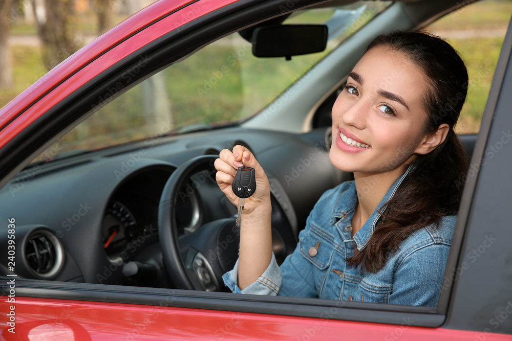 Happy woman showing key from new car Happy woman showing key from new car