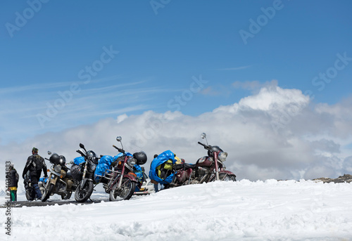 TANGLANG LA PASS, LADAKH , INDIA  JULY 20, 2015: Tourists relaxing  on the summit of the Tanglang La pass is the second highest motorable road in the world at 5400m photo
