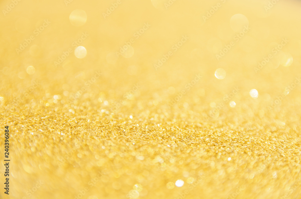 Defocused gold glitter background. Gold abstract bokeh background. Christmas abstract background Defocused gold glitter background. Gold abstract bokeh background. Christmas abstract background