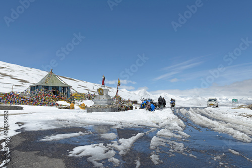 TANGLANG LA PASS, LADAKH , INDIA  JULY 20, 2015: Tourists relaxing  on the summit of the Tanglang La pass is the second highest motorable road in the world at 5400m photo