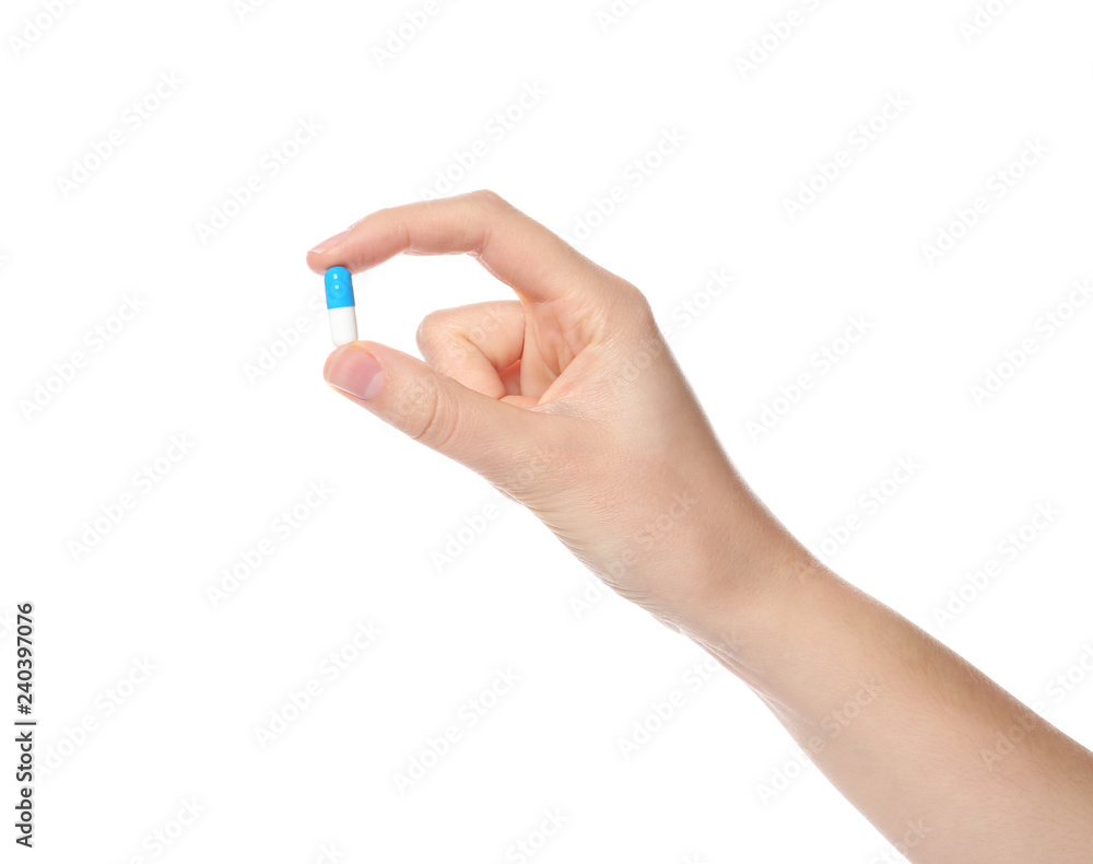 Woman holding color pill on white background, closeup Woman holding color pill on white background, closeup