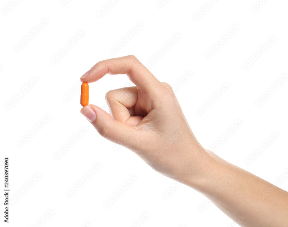 Woman holding color pill on white background, closeup Woman holding color pill on white background, closeup
