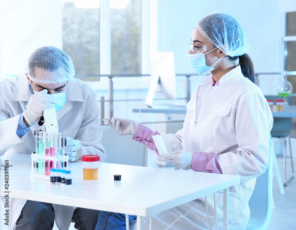 Young scientists working in laboratory. Chemical analysis Young scientists working in laboratory. Chemical analysis