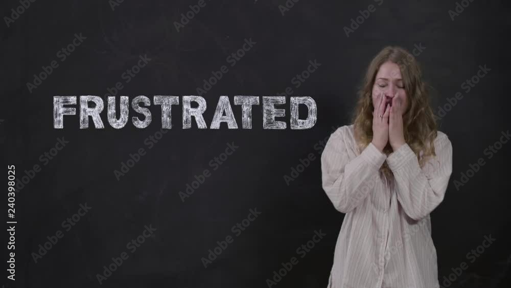 Portrait of woman in pajamas yawning and covering her mouth with her hand