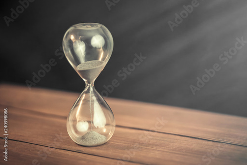 Hourglass on wooden background