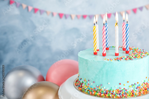 Photography Fresh delicious birthday cake with candles near balloons on color background