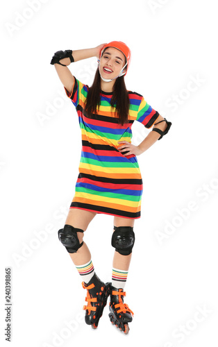 Full length portrait of young woman in bright dress with roller skates on white background © New Africa