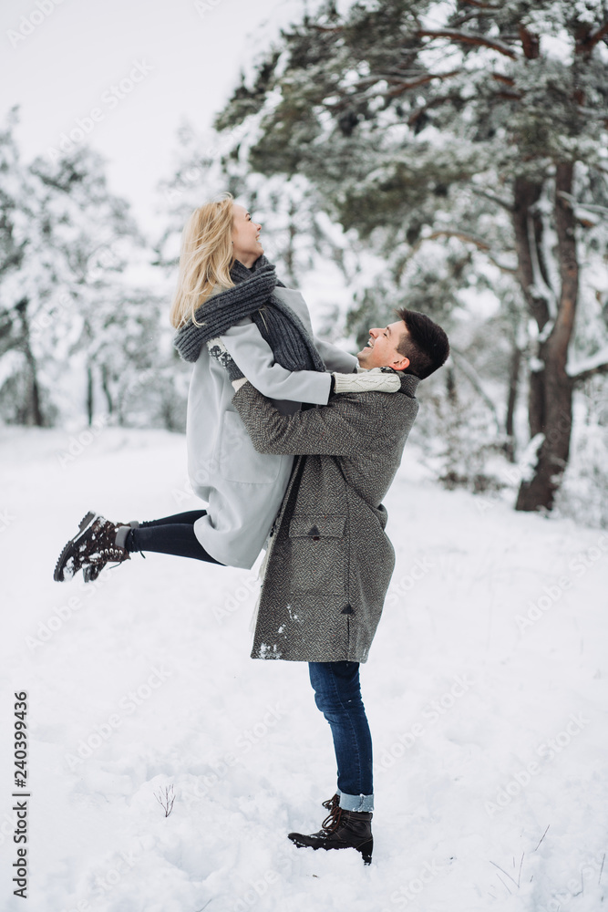 Happy Couple Having Fun Outdoors in Snow Park. Happy Couple Having Fun Outdoors in Snow Park.