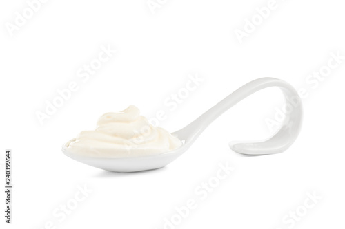 Serving spoon with sour cream on white background