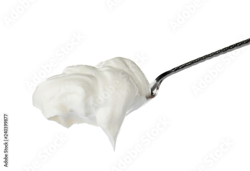 Metal spoon with sour cream on white background