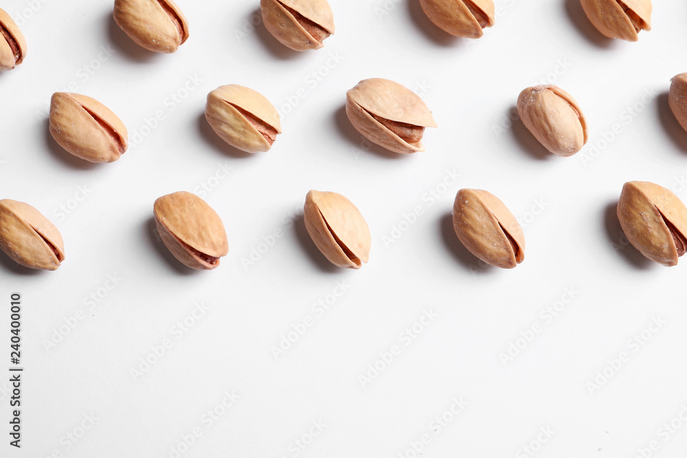 Organic pistachio nuts on white background, flat lay. Space for text Organic pistachio nuts on white background, flat lay. Space for text