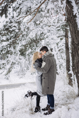 Happy young couple have fun outside in snow park