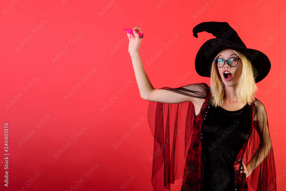 Pretty surprised woman dressed as fairy holds marker. Back to school. School supplies. Gorgeous happy fairy enchantress in hat. Carnival costumes. Sexy enchantress in black dress with marker in hand. Pretty surprised woman dressed as fairy holds marker. Back to school. School supplies. Gorgeous happy fairy enchantress in hat. Carnival costumes. Sexy enchantress in black dress with marker in hand.