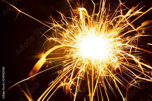 Christmas sparkler isolated on black background. Bengal fire