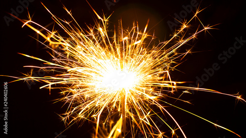 Christmas sparkler isolated on black background. Bengal fire