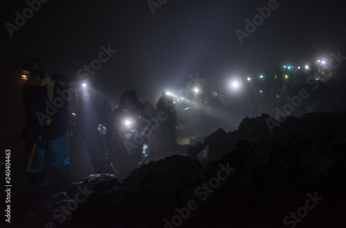 Climbers walking in the mountain path of the night