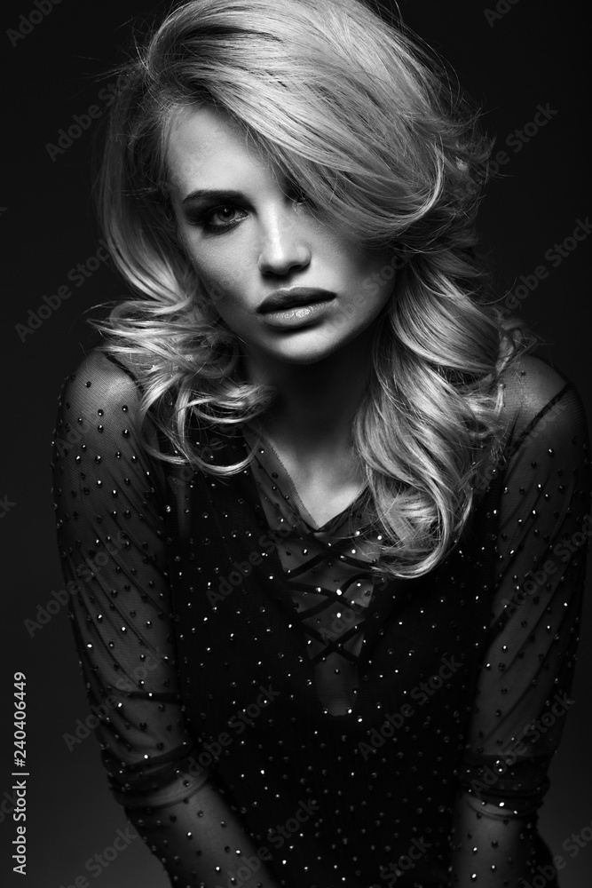 Portrait of a beautiful blonde close-up on a black background Portrait of a beautiful blonde close-up on a black background